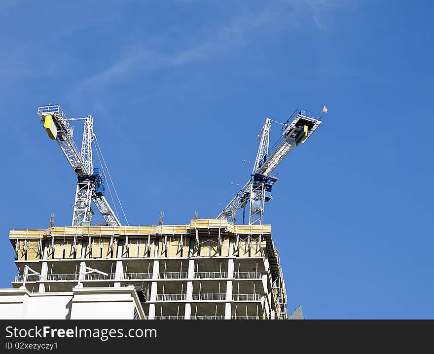 Two cranes atop new construction