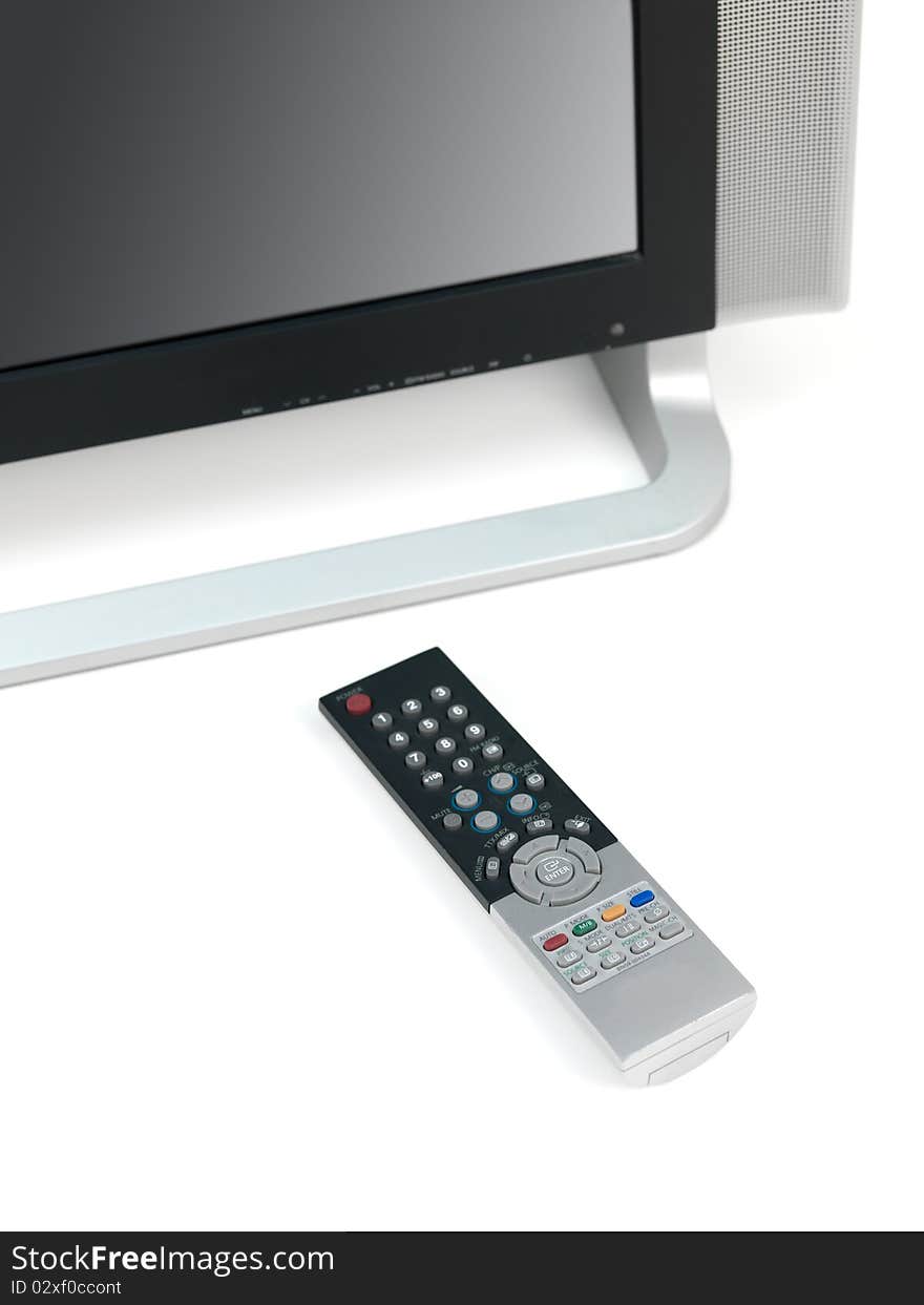 A LCD TV monitor and remote control isolated against a white background