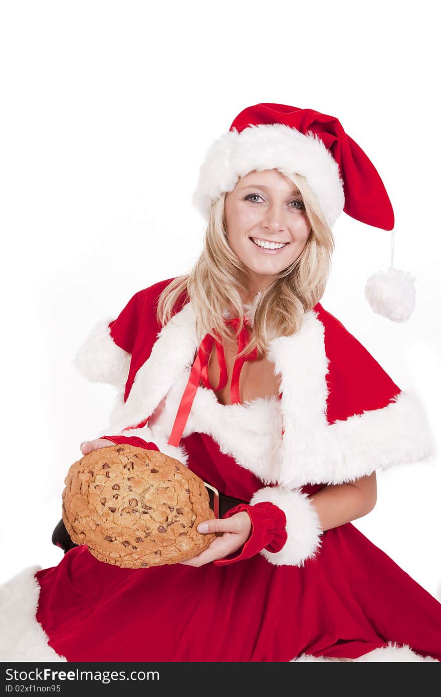 A female dressed like Santa with a big cookie. A female dressed like Santa with a big cookie.