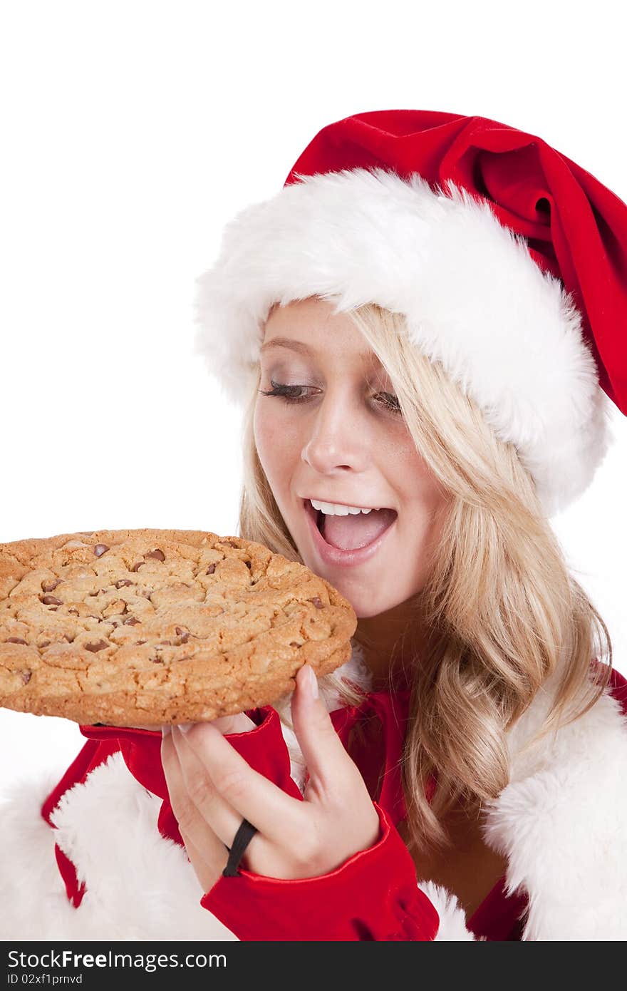 A female dressed like Santa with a big cookie. A female dressed like Santa with a big cookie.