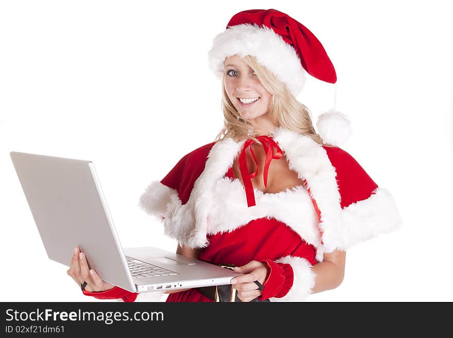 A female dressed as santas helper making a list on a laptop. A female dressed as santas helper making a list on a laptop.