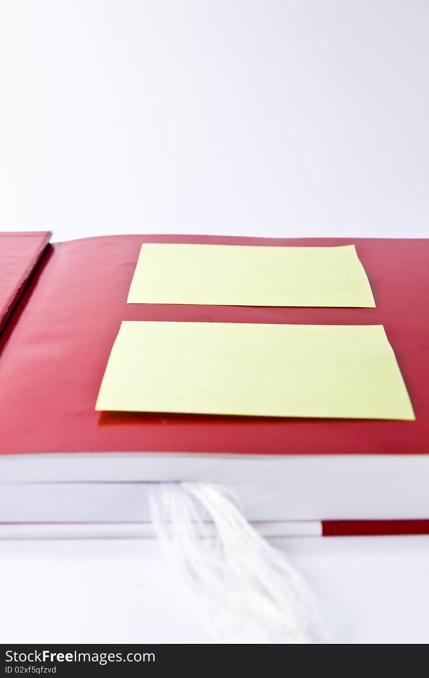 Yellow note on red notebook