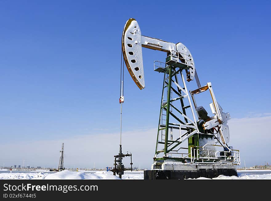 Cold winter, oil producing equipment is covered with snow. Cold winter, oil producing equipment is covered with snow