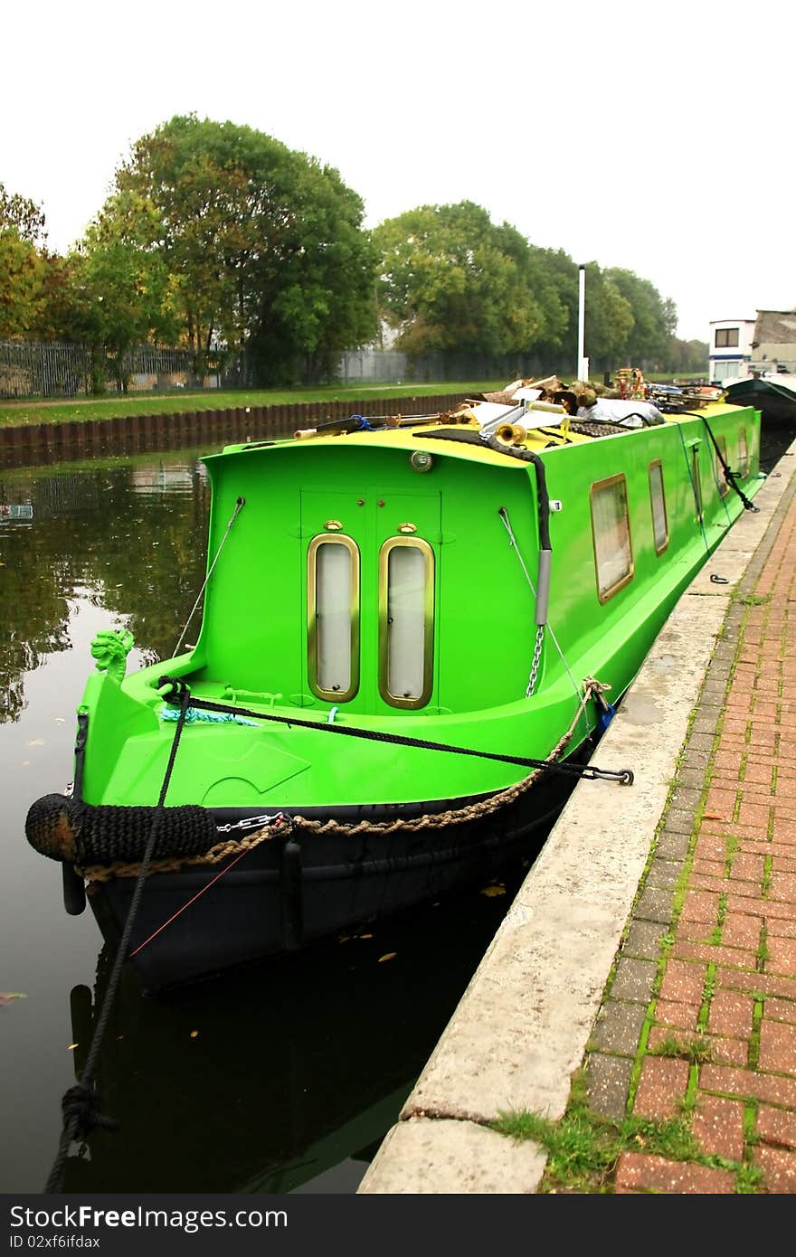 Image of a green painted canal boat in London. Image of a green painted canal boat in London