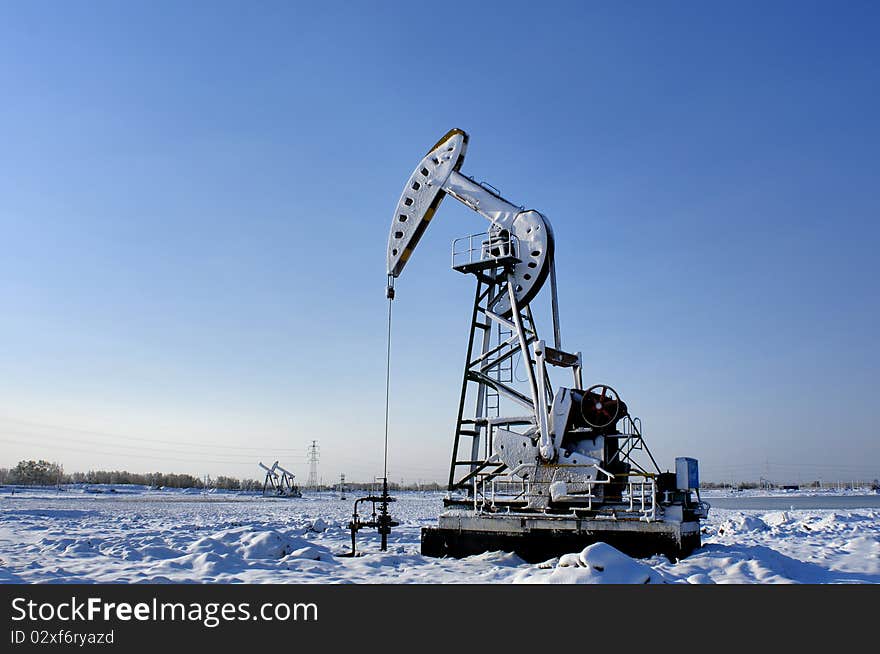 Cold winter, oil producing equipment is covered with snow. Cold winter, oil producing equipment is covered with snow