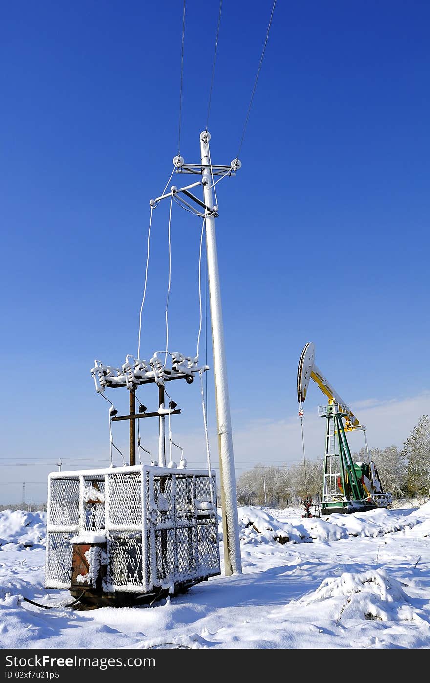 Cold winter, oil producing equipment is covered with snow. Cold winter, oil producing equipment is covered with snow