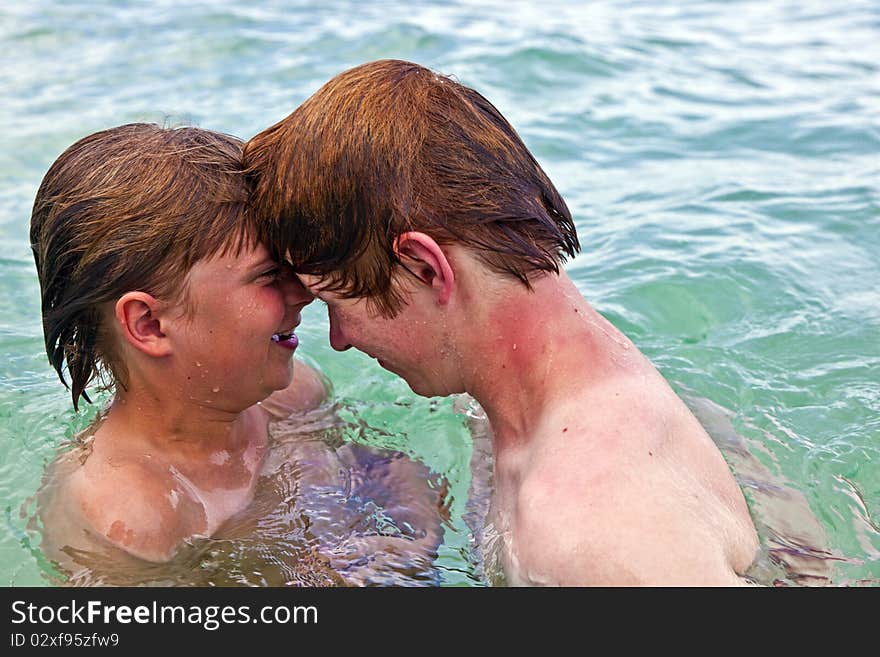 Boys having fun in the clear sea