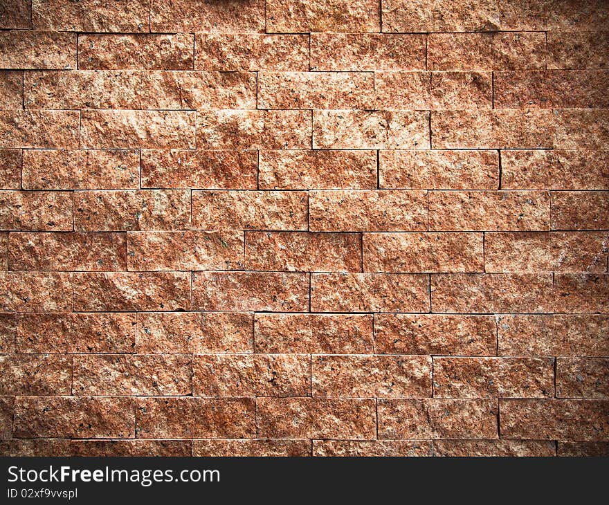 Texture of rectangle pattern red stone on wall