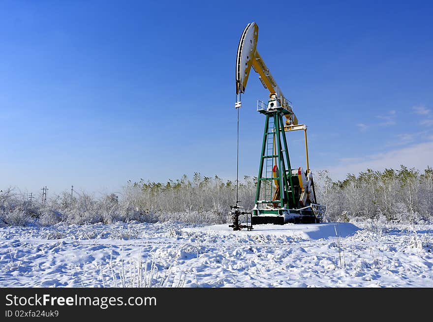 Cold winter, oil producing equipment is covered with snow. Cold winter, oil producing equipment is covered with snow