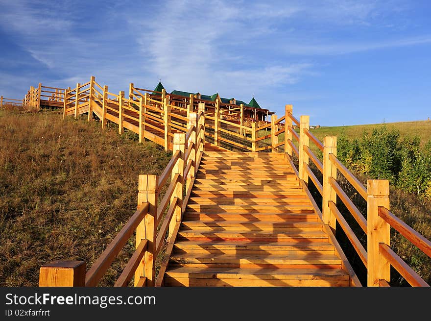 Warm light shines on the wooden bridge above