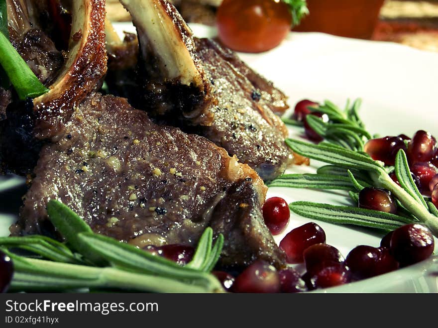 Fried rib served with pomegranate and salad. Fried rib served with pomegranate and salad