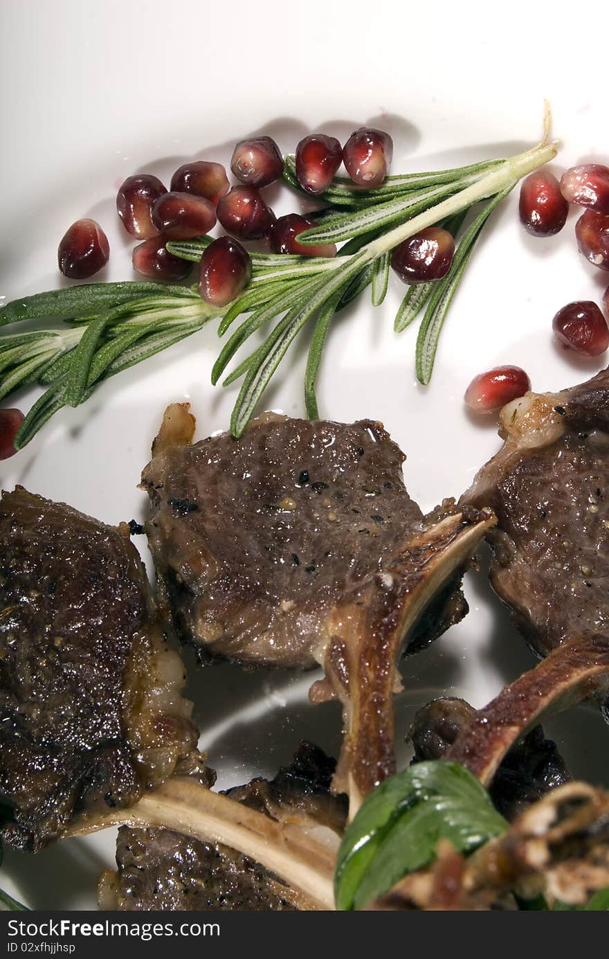 Fried rib served with pomegranate and salad. Fried rib served with pomegranate and salad