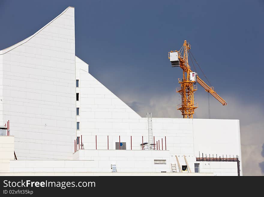 Modern building's construction again a troubled sky