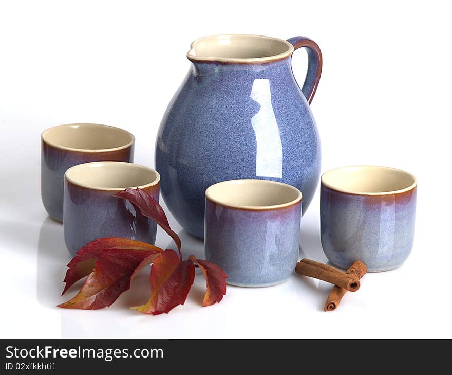 The photo shows a teapot and some teacups over white. The photo shows a teapot and some teacups over white