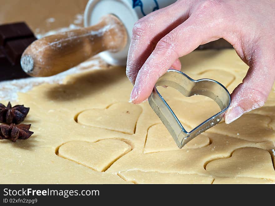 Heart ramekins are gouged in the dough. Heart ramekins are gouged in the dough