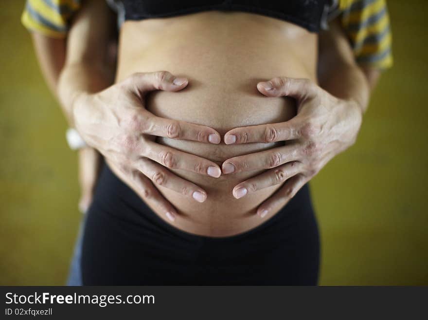 Father holding with hand pregnant belly of a woman. Father holding with hand pregnant belly of a woman