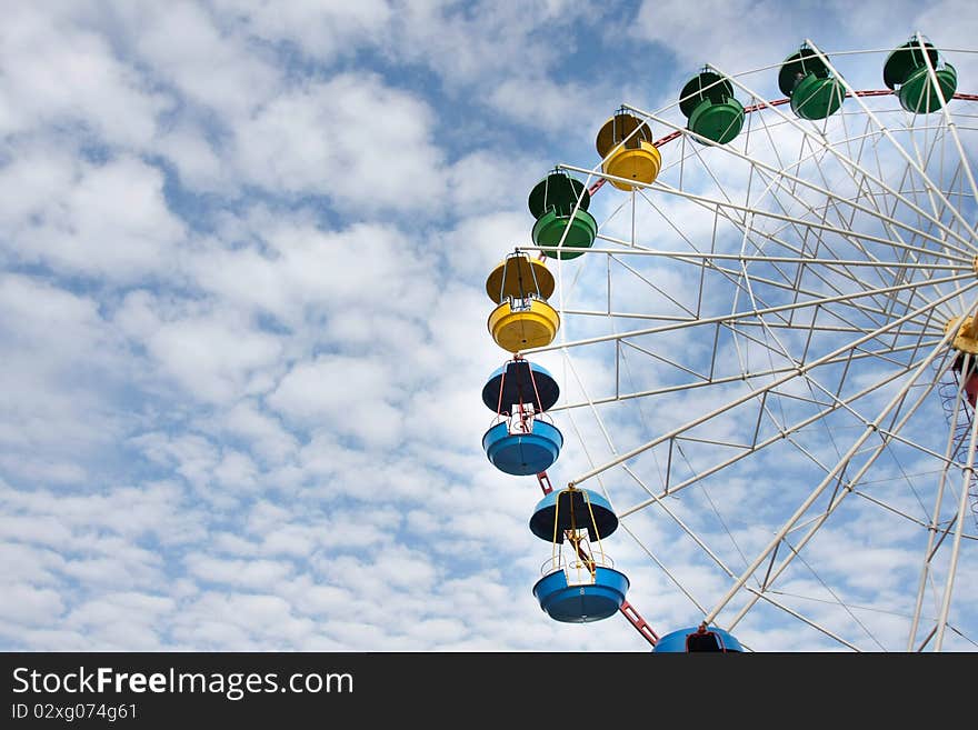 Ferris wheel on sky background