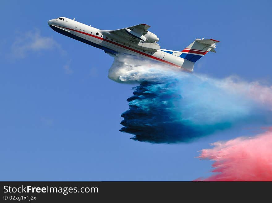 Firefighter airplane spraying tricolor cloud of water