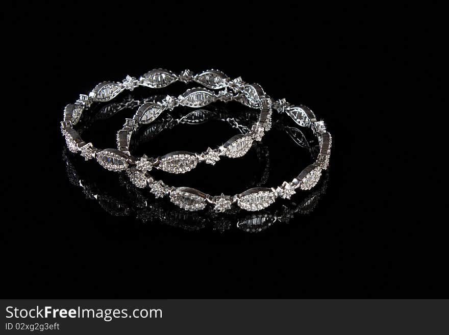 Diamond bracelet with many stones on reflective background