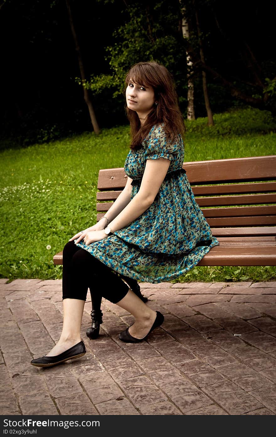 Pretty Girl Sitting On A Bench