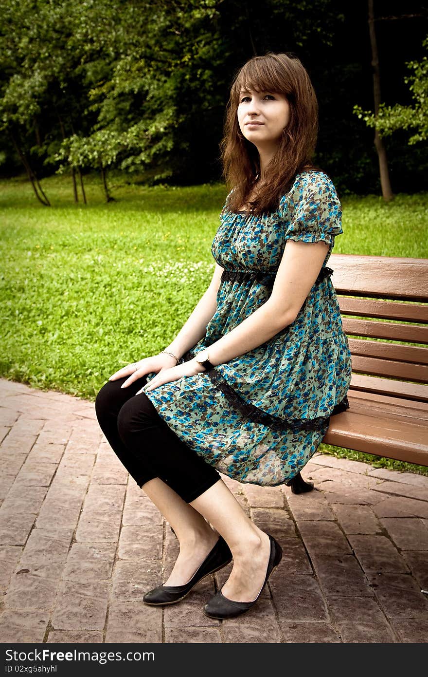 Pretty girl sitting on a bench