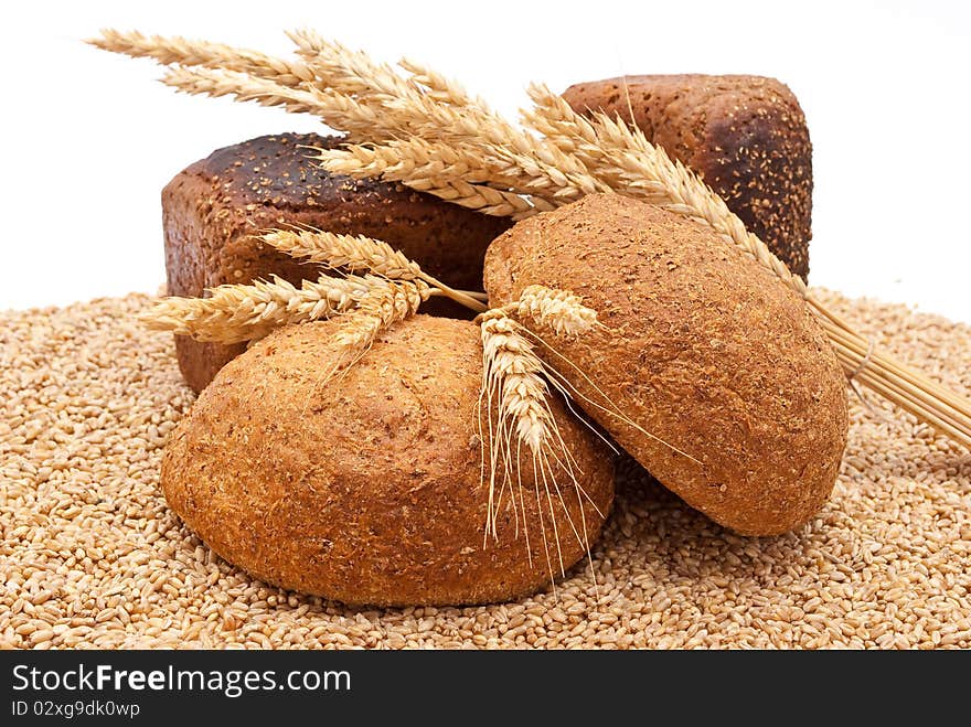 Bread with wheat and ears on white