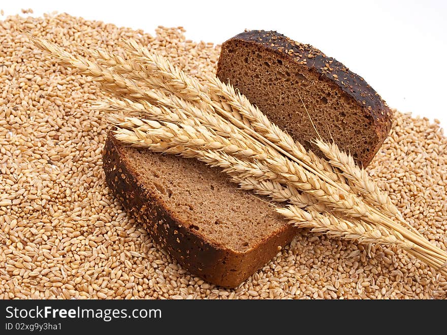 Bread with wheat and ears on white