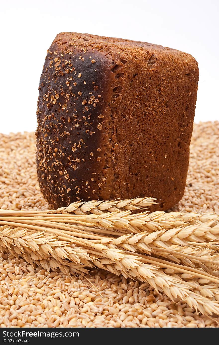 Bread with wheat and ears on white