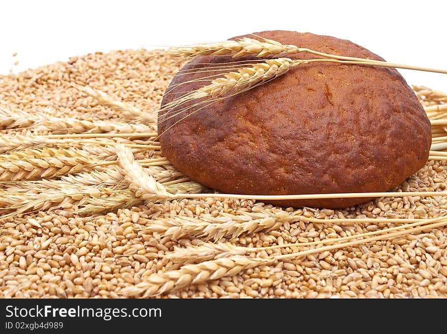 Bread with wheat and ears on white