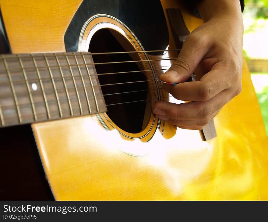 Man playing folk guitar with left hand