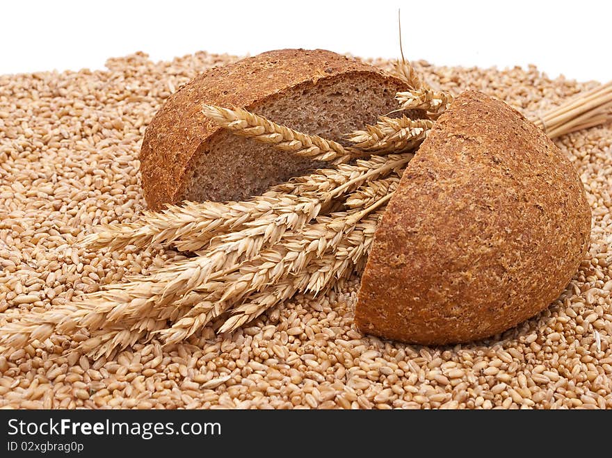 Bread with wheat and ears on white