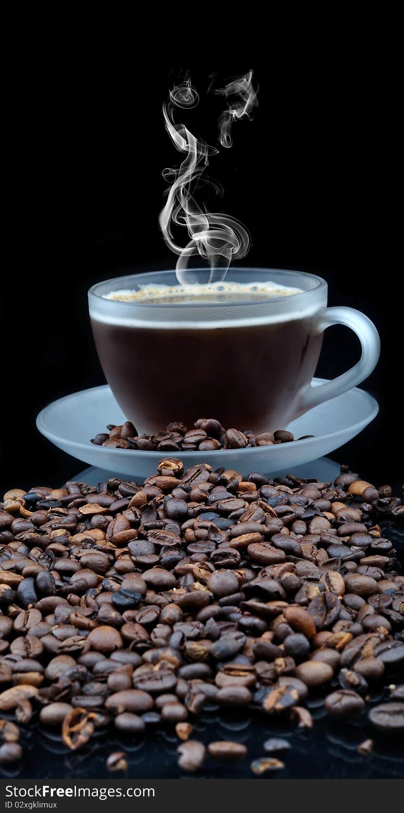 Pure glass with coffee with smoke and granules on black table. Pure glass with coffee with smoke and granules on black table