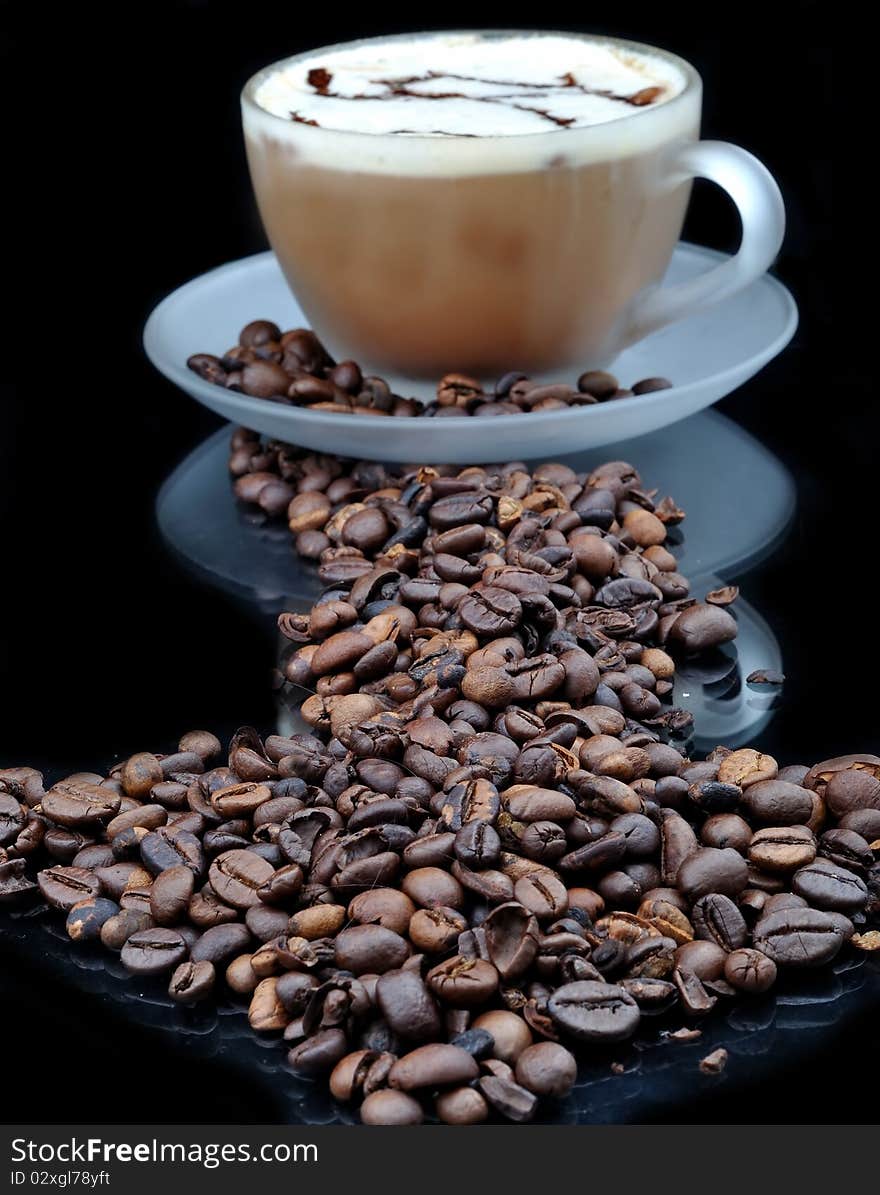 Pure glass with coffee with smoke and granules on black table. Pure glass with coffee with smoke and granules on black table