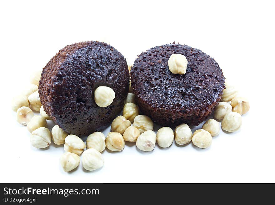 Chocolate muffins with nuts on a white background