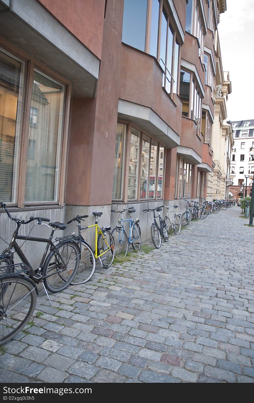 This is very typical in Stockholm, Sweden to see bikes leaning against buildings. This is very typical in Stockholm, Sweden to see bikes leaning against buildings.