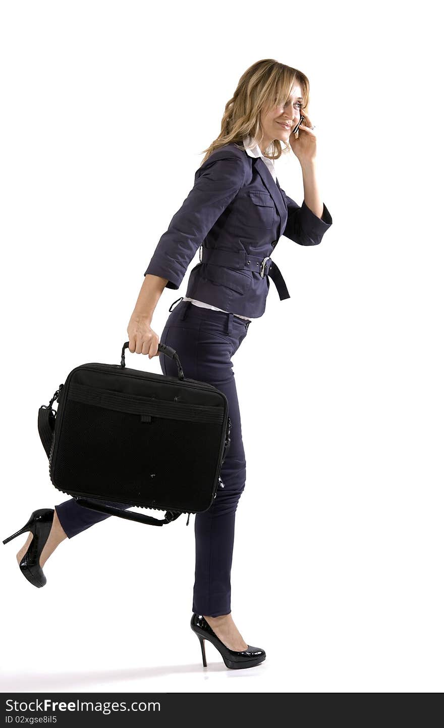 Young businesswoman with briefcase talk on the phone. Young businesswoman with briefcase talk on the phone