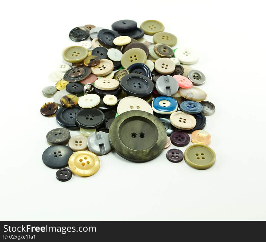 Buttons of many colors on a white background