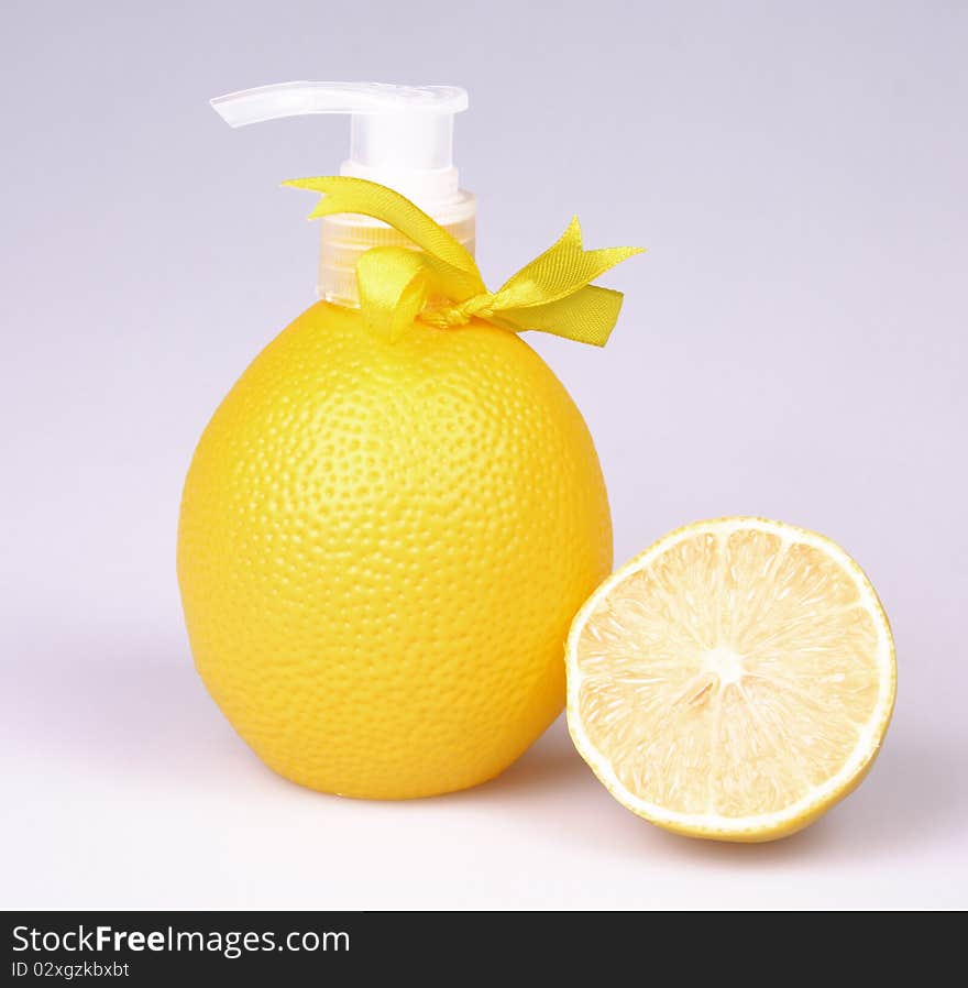 Container with liquid soap in a combination to fruit