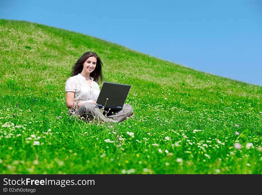 Beautiful  woman with notebook  on hill