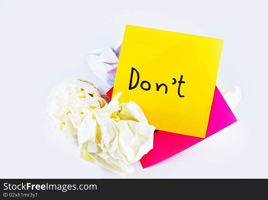 Wrinkled paper with note pad reminder don't isolated on white background