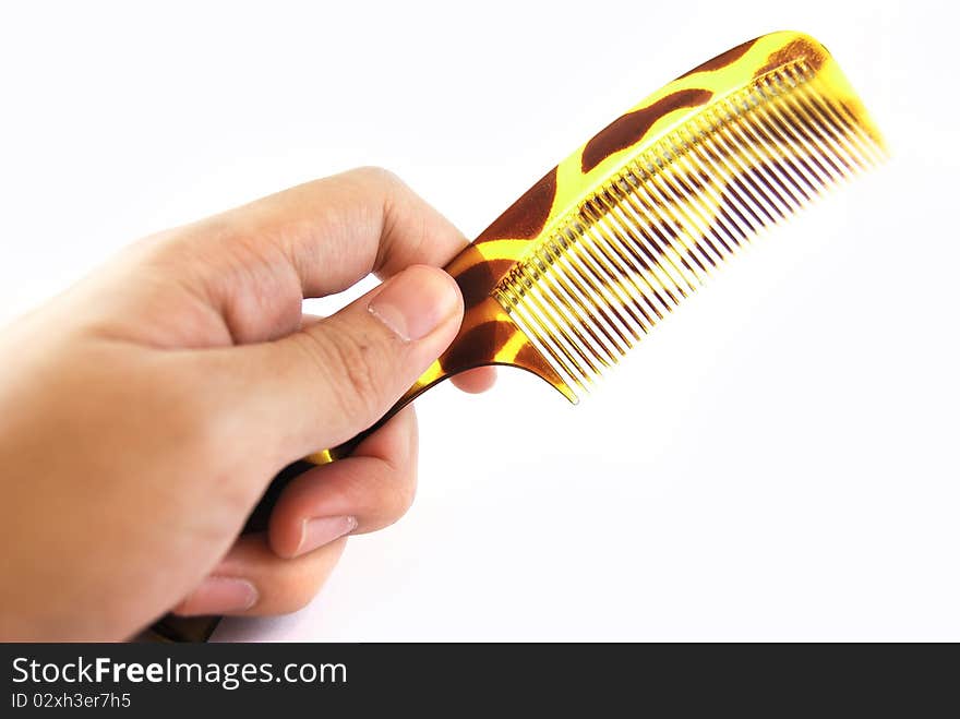 Hand Holding Green Comb Isolated