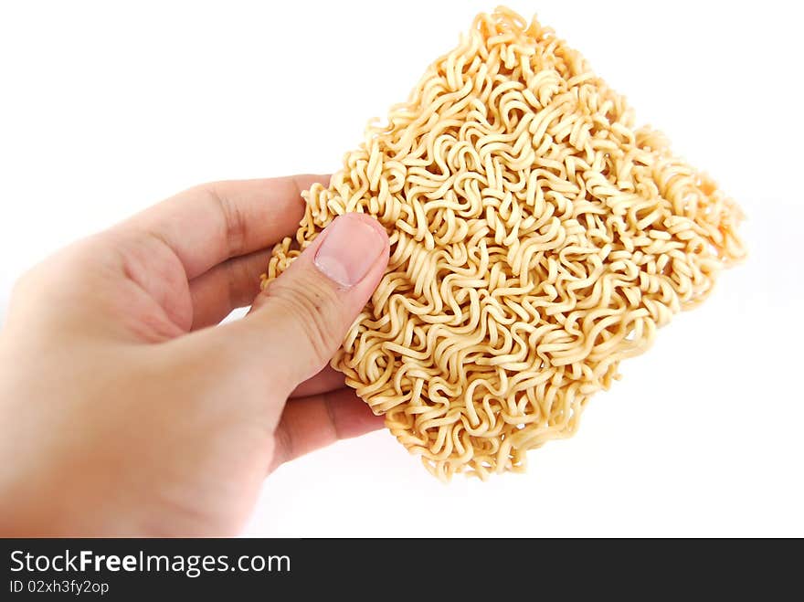 Hand holding a block of Instant noodles isolated on white background