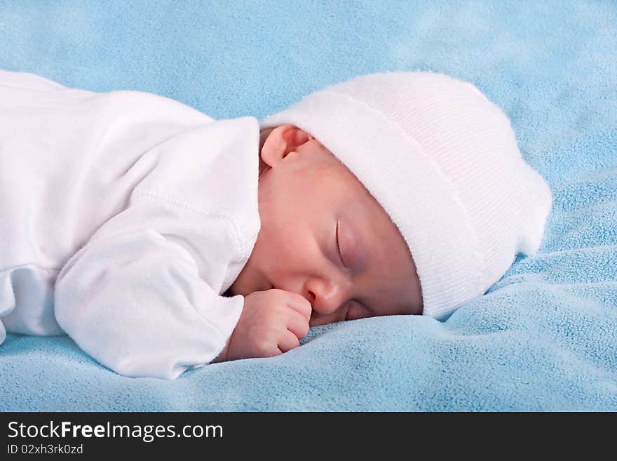 The sleeping kid on a blue background