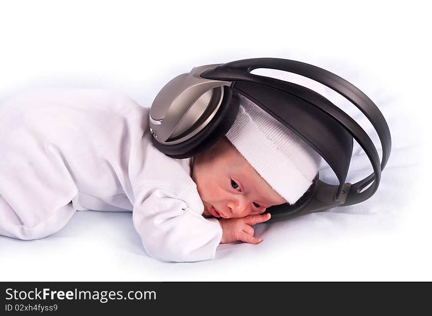 The newborn kid listening to music through ear-phones