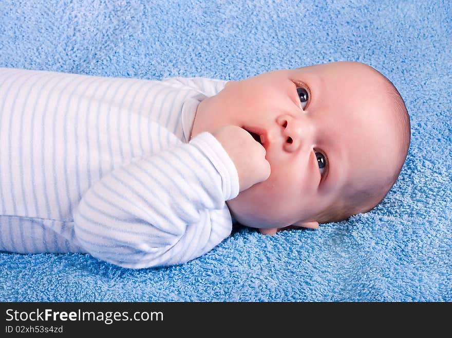 The child in thoughtfulness on a blue background