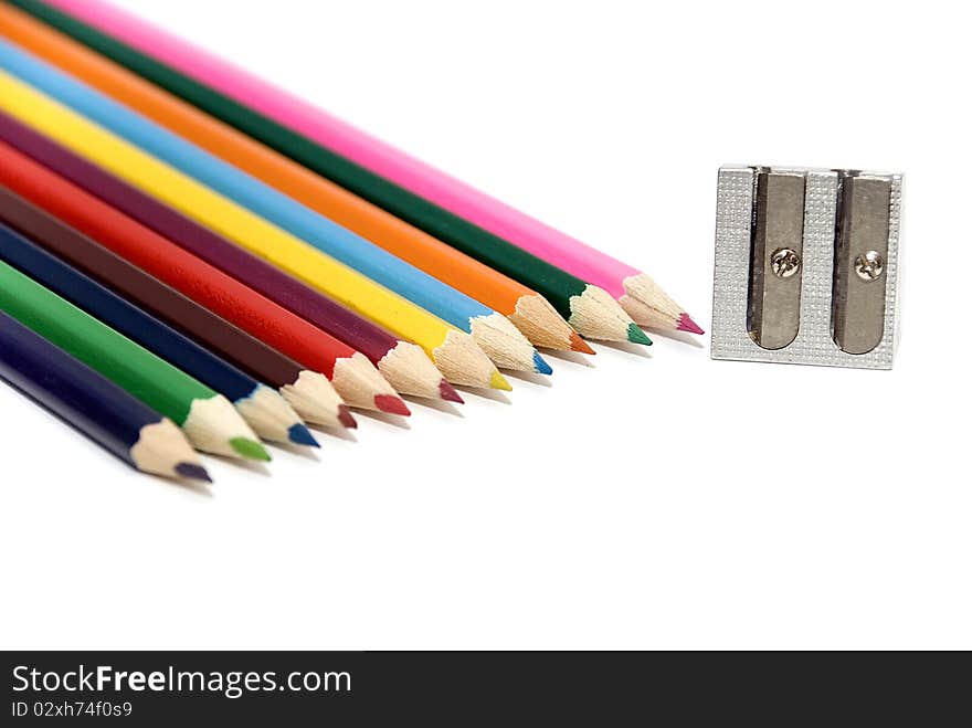 12 colored crayons with sharpener on white background. 12 colored crayons with sharpener on white background