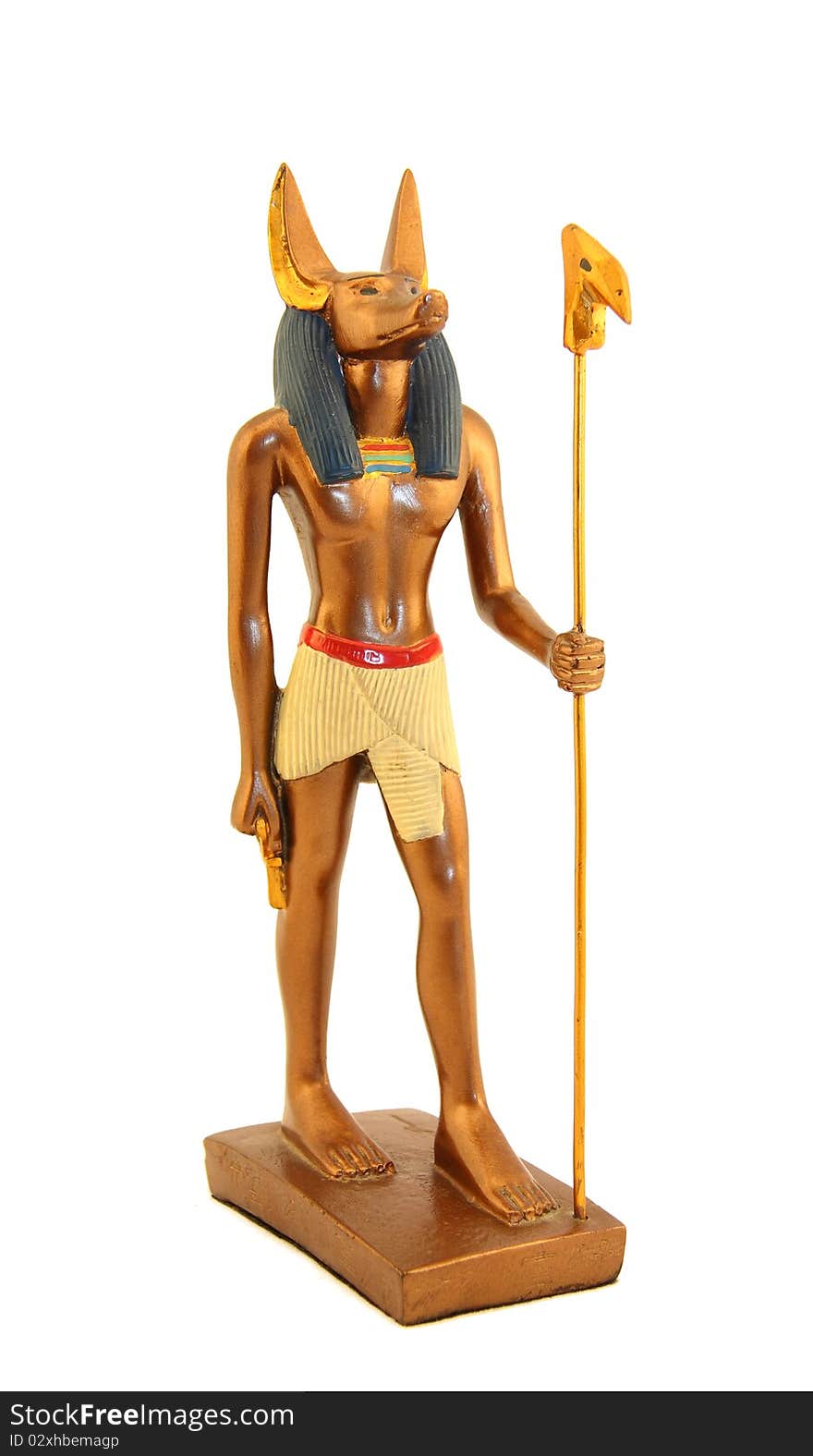 Figurine of Egyptian god anubis gold color with a staff. Figurine of Egyptian god anubis gold color with a staff