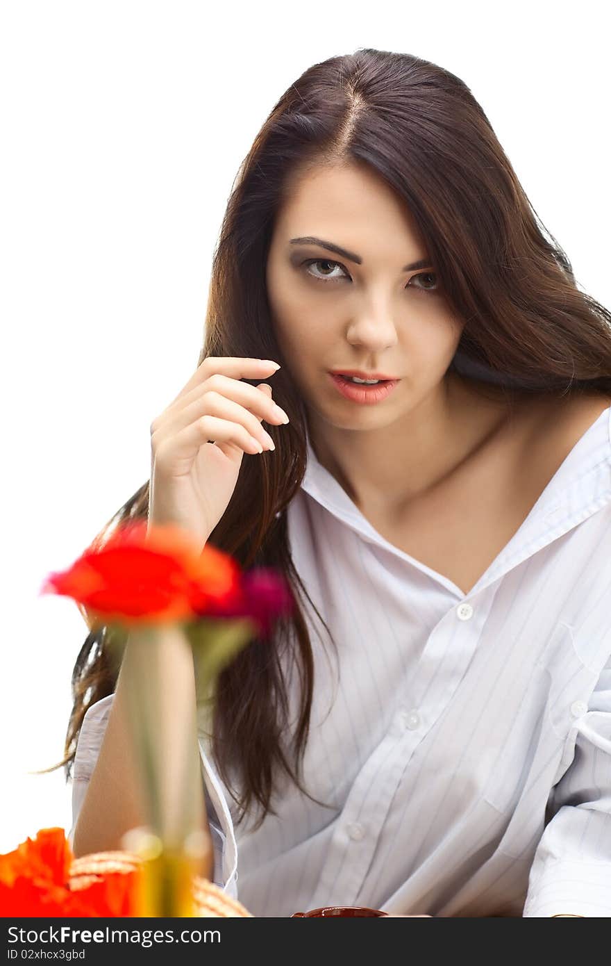 Beautiful woman in cafe over white background with red flowers. Beautiful woman in cafe over white background with red flowers