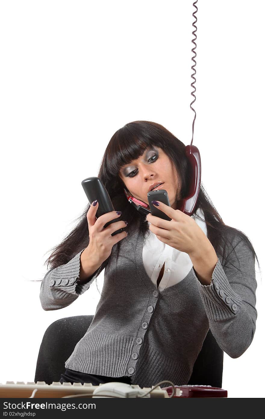 Businesswoman speak by four phones at the same time on her workspace