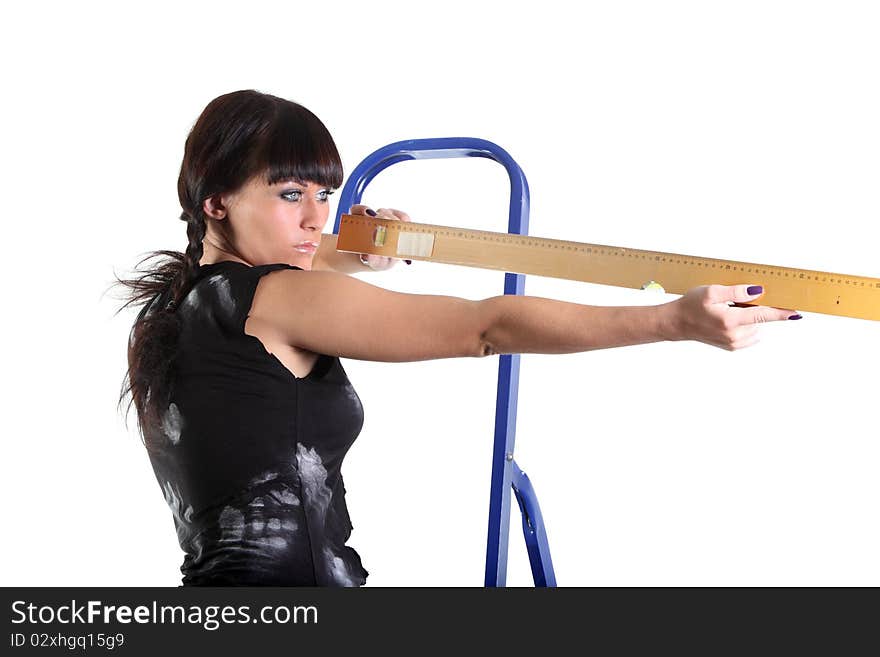 Girl in a ragged t-shirt look along a yellow ruler. Girl in a ragged t-shirt look along a yellow ruler